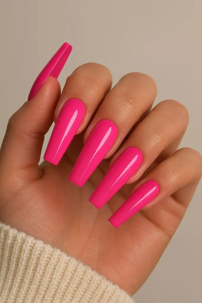 Hot pink glossy coffin acrylic nails with bold vivid color