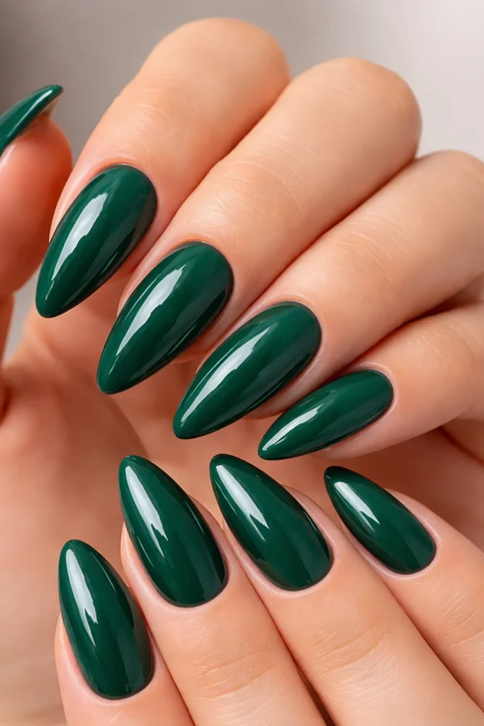Jade green almond nails with a glossy finish that elongates and flatters the fingers