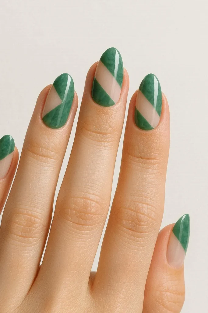 Jade green nails with negative space geometric design leaving part of the nail bare