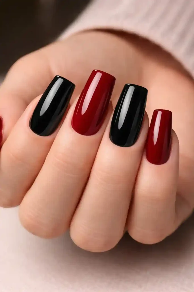 Black and deep red alternating dual-tone nails on square nails with glossy finish