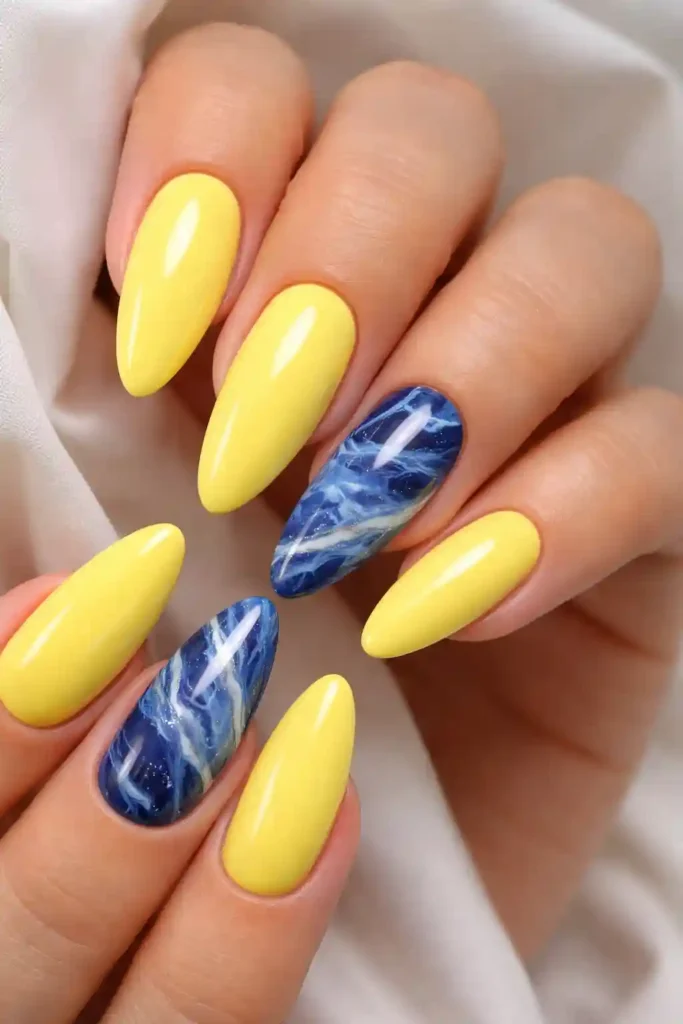lemon yellow almond nails with cobalt blue marble accent nail