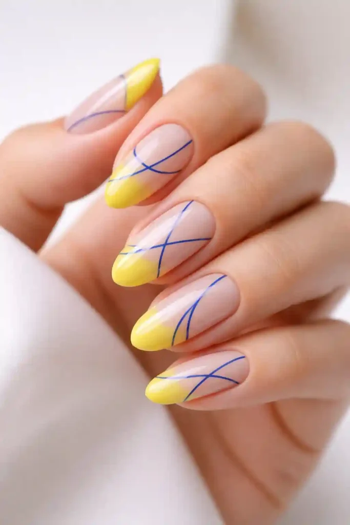 lemon yellow negative space nails with cobalt blue line art