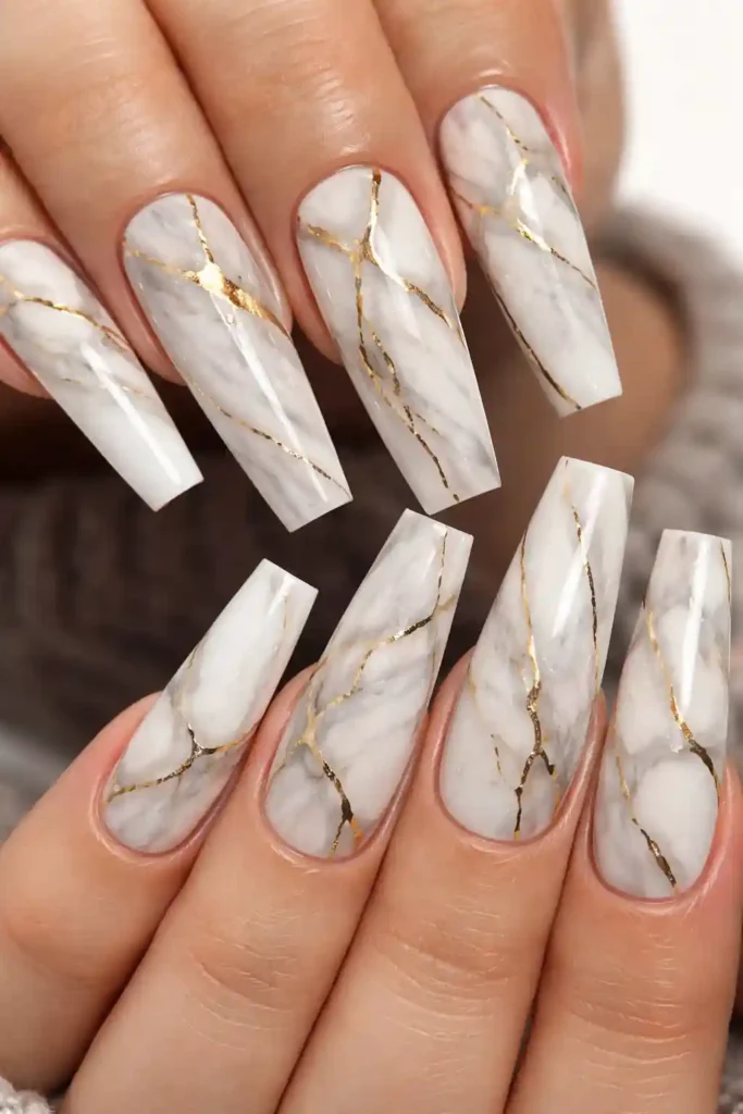 White marble coffin nails with delicate gold veins and a high-gloss topcoat