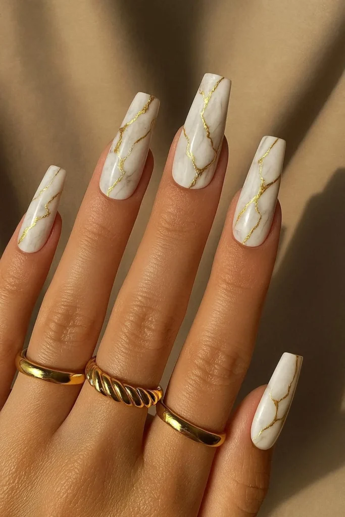 White marble acrylic nails with hand-painted gold veining