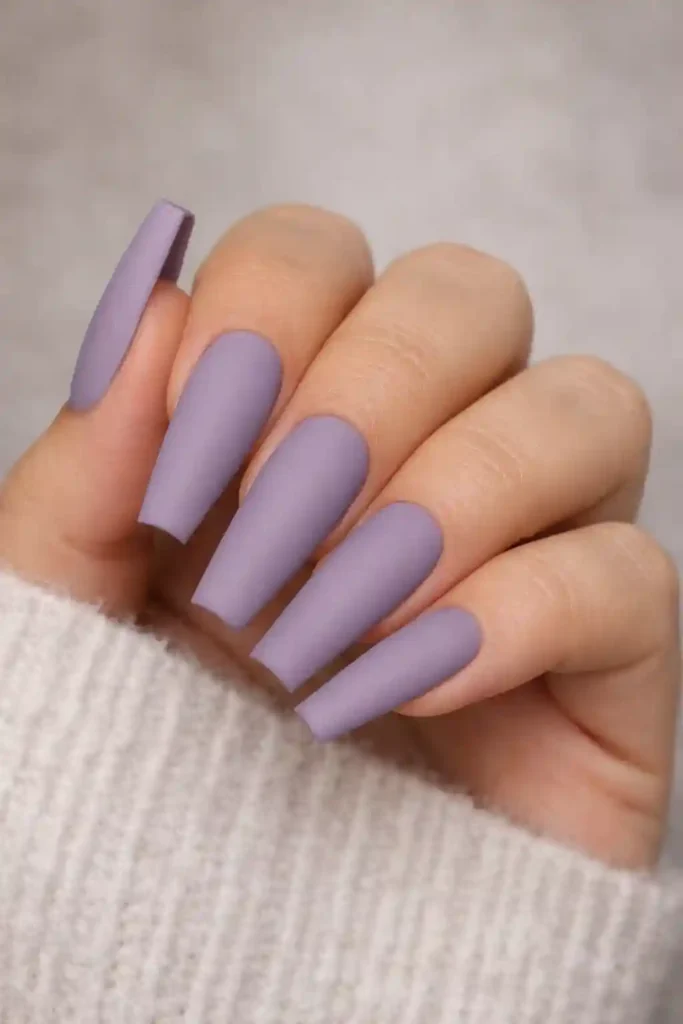 Matte lavender coffin nails in dusty purple with velvety smooth finish on long nails