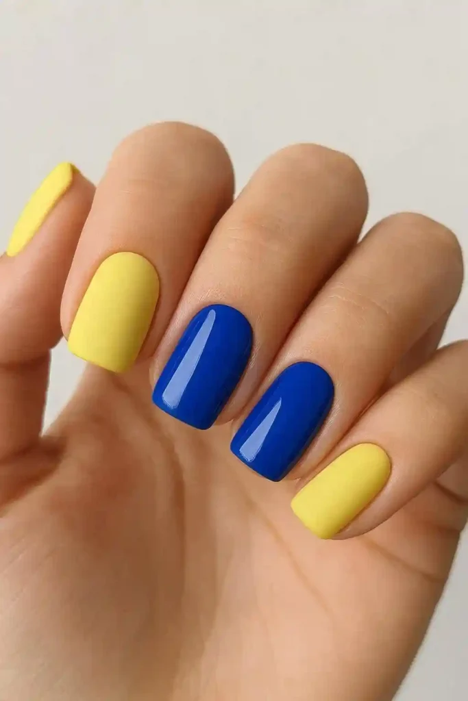 matte lemon yellow nails beside glossy royal blue nails