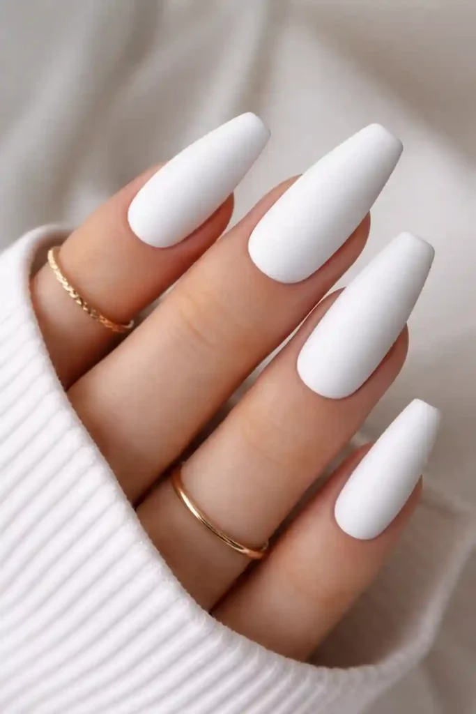 Matte white nails with a velvety flat finish on almond-shaped nails