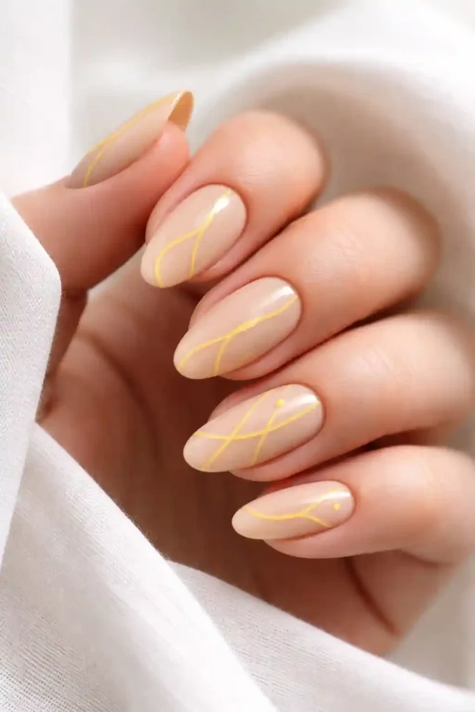 Minimalist yellow line art nails on nude base
