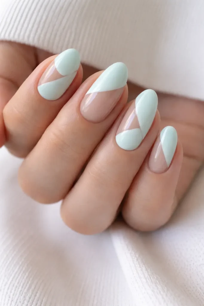 Mint negative space pastel nail designs with geometric shapes and bare nail sections