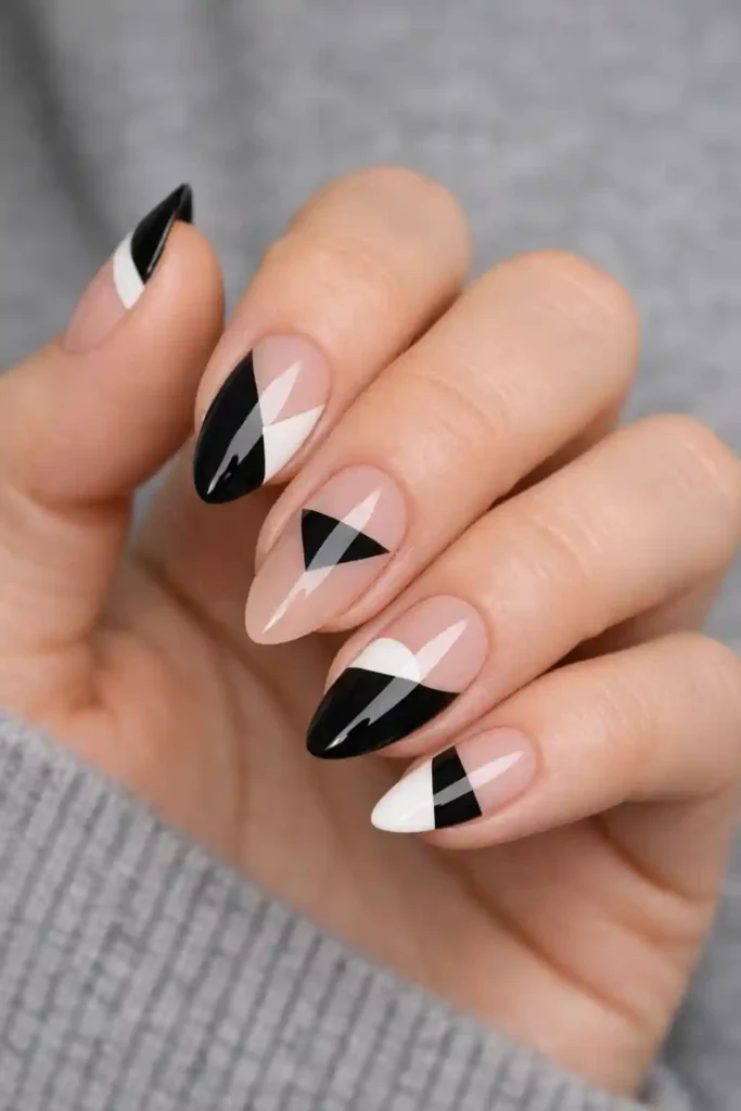 Negative space geometric almond nails with diagonal lines and bare nail design
