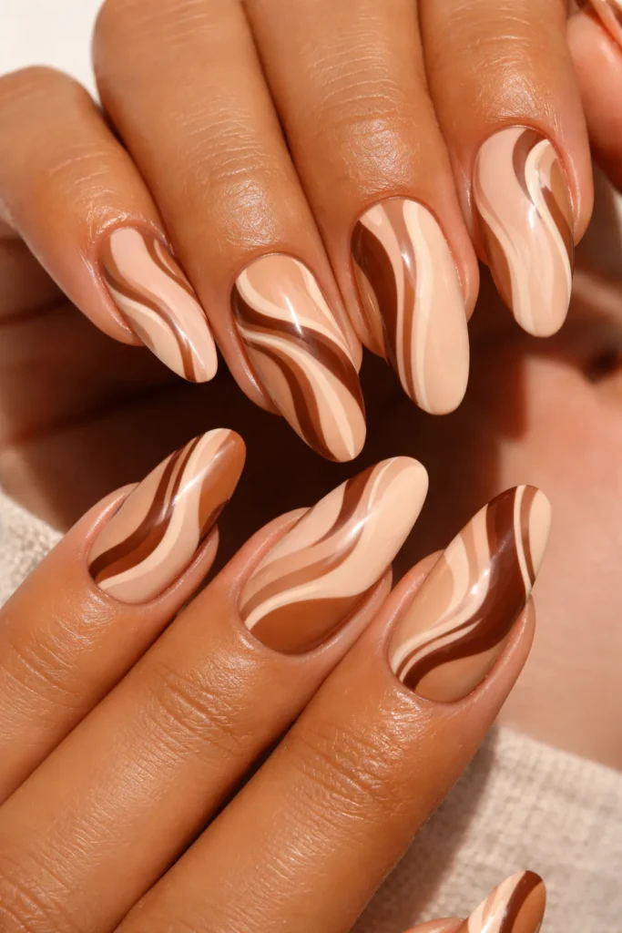 Nude and brown swirl nail design