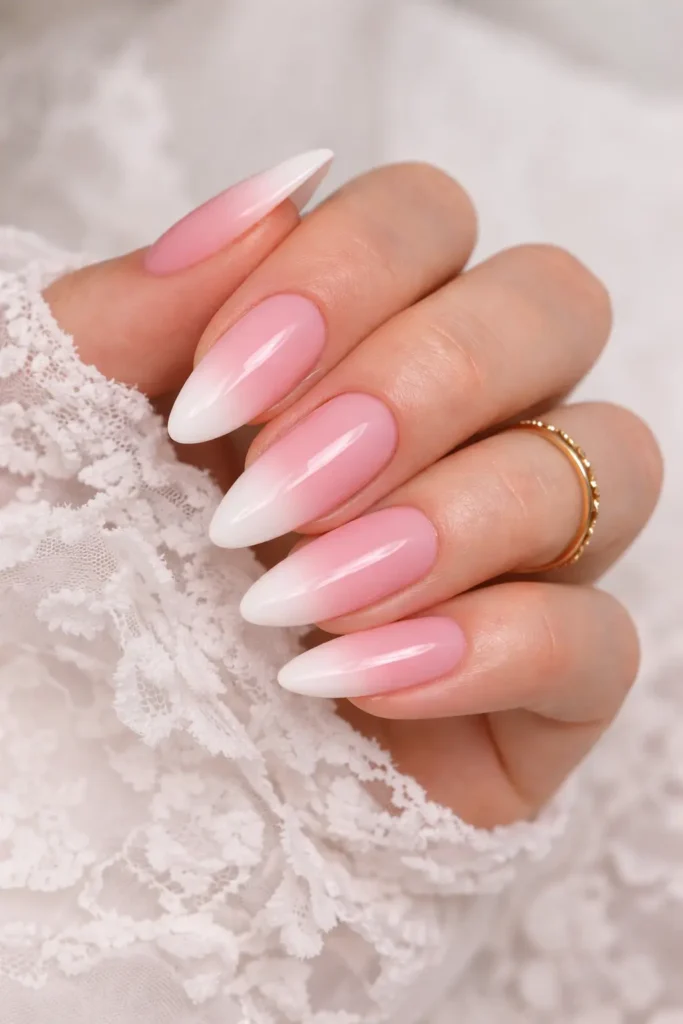 ombre almond nails with blush pink to translucent white gradient for a bridal manicure
