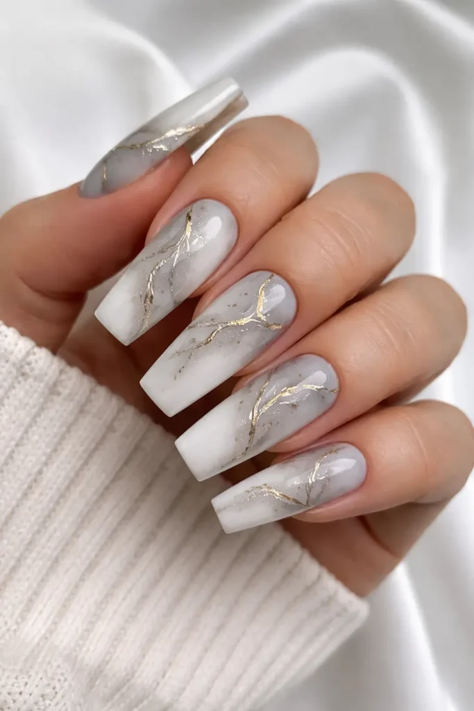 ombre marble nails with grey to white gradient and gold marble veins on coffin nails
