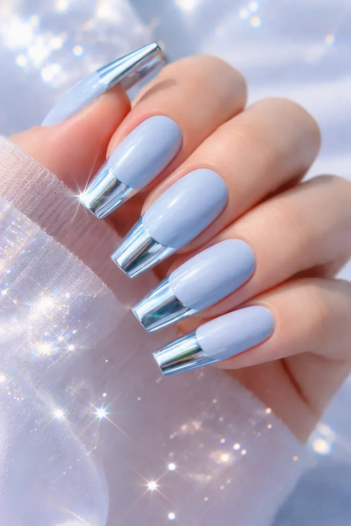 Pastel blue chrome French tip nails with mirror finish on almond shape