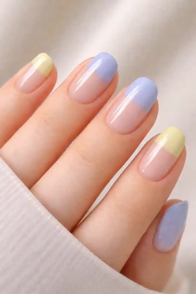 pastel lemon yellow and periwinkle blue minimalist nail set with negative space