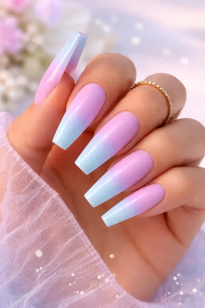 Pastel ombre coffin nails fading from lilac to baby blue with a glossy finish