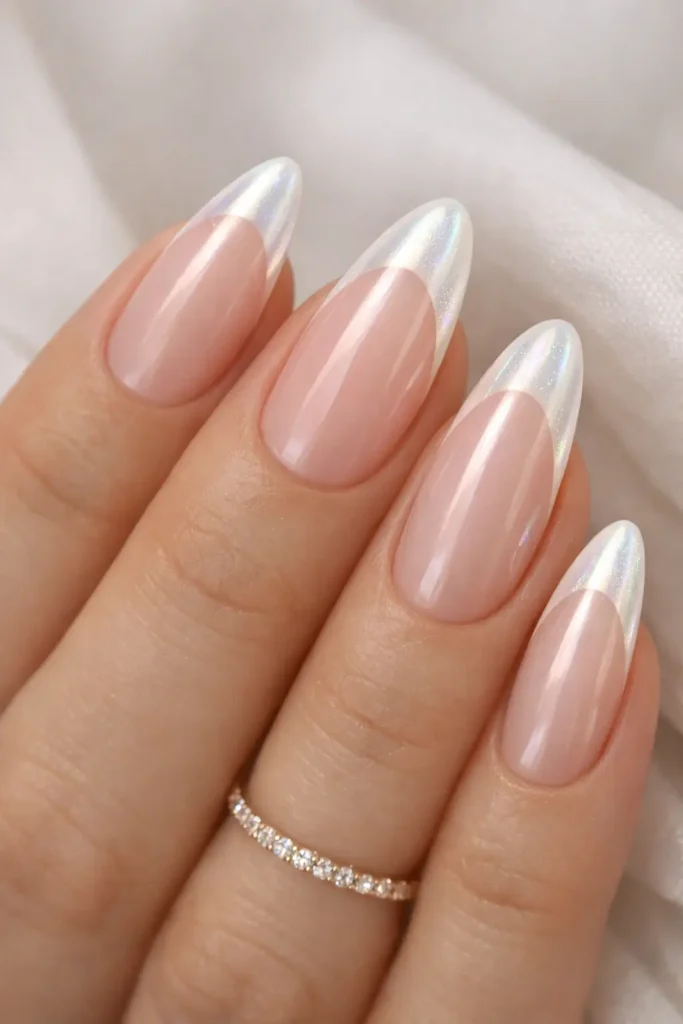 Pearl french tip nails with iridescent opalescent white pearlescent tips on long almond oval nails