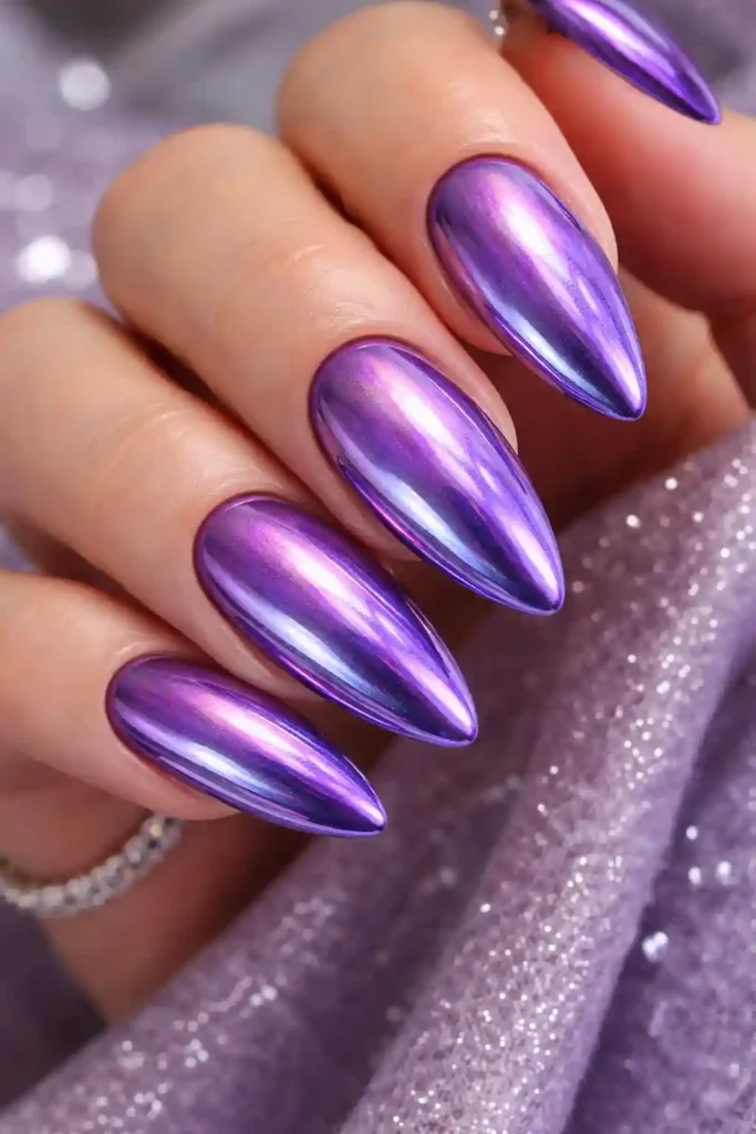 Purple chrome nails with mirror like holographic finish on long almond nails