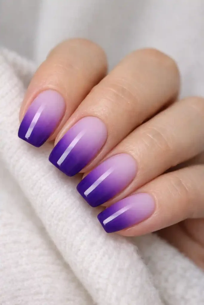 Purple ombre nails blending soft lilac to deep violet gradient