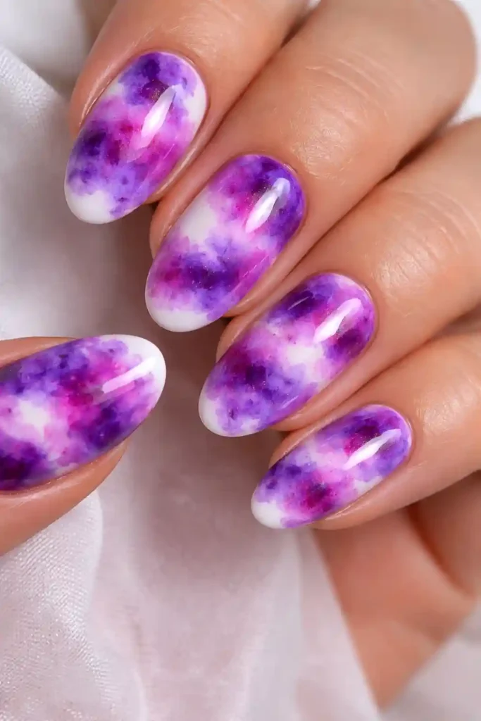 Purple tie dye nails with lavender violet magenta and plum swirled on white base