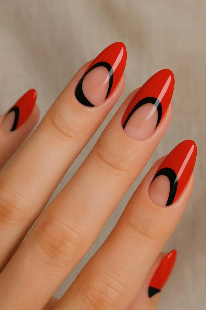 Red acrylic nails with black negative space nail art design