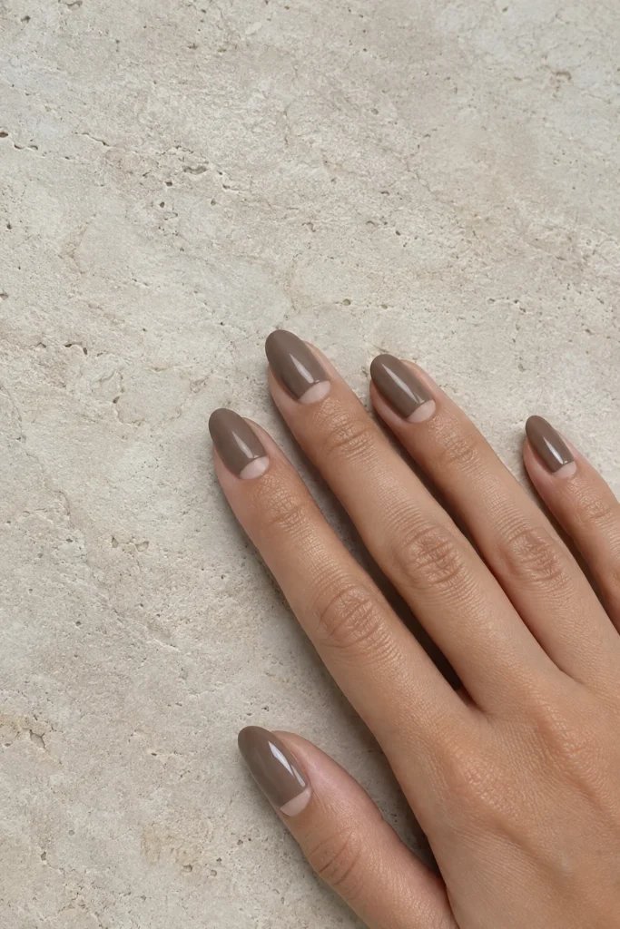 Reverse half moon minimalist nails with taupe polish
