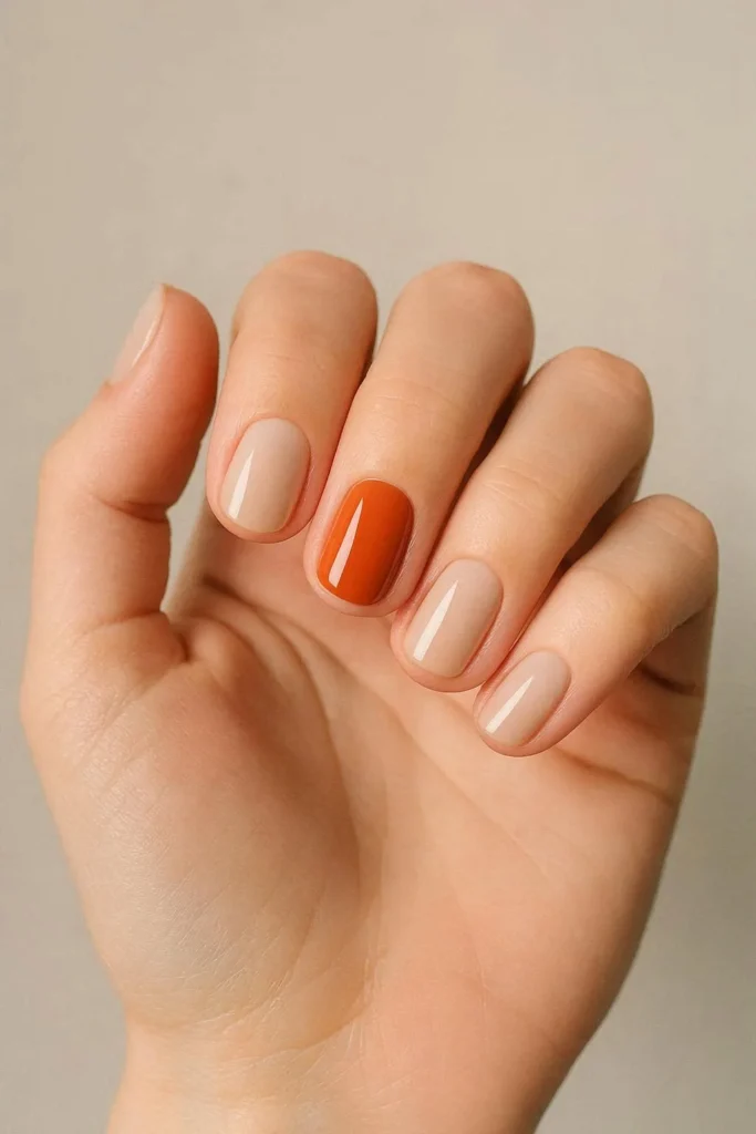 Single forest green accent nail on neutral nude set