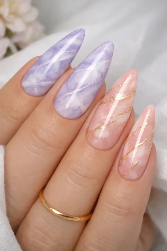 Spring marble nails with soft lavender and white veining on a blush pink base