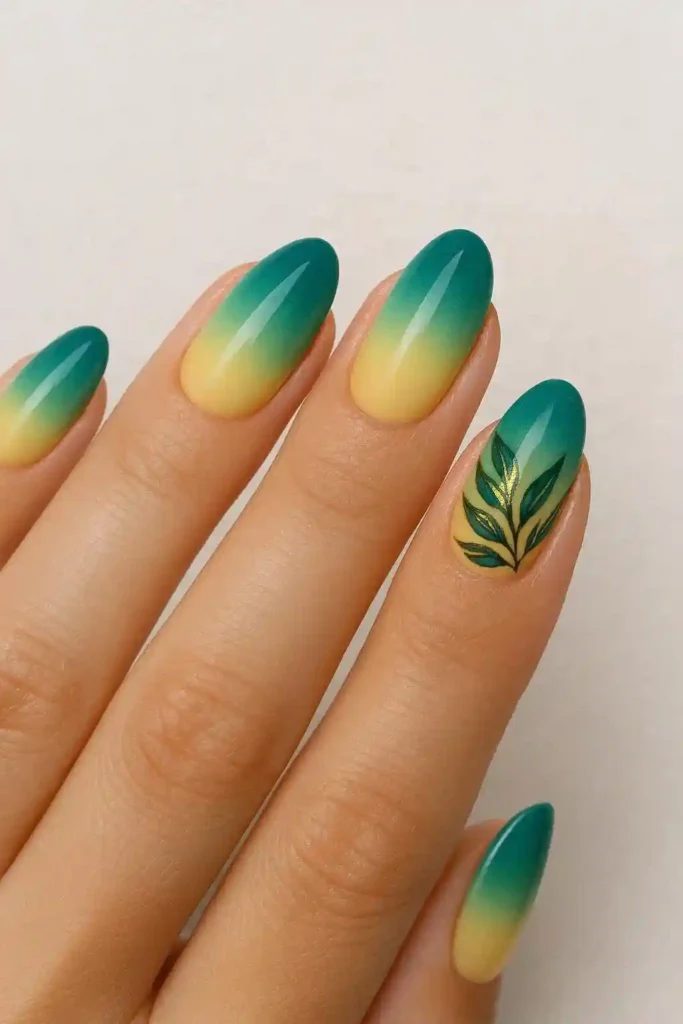 tropical teal to lemon yellow ombre nails with hand-painted leaf art accent