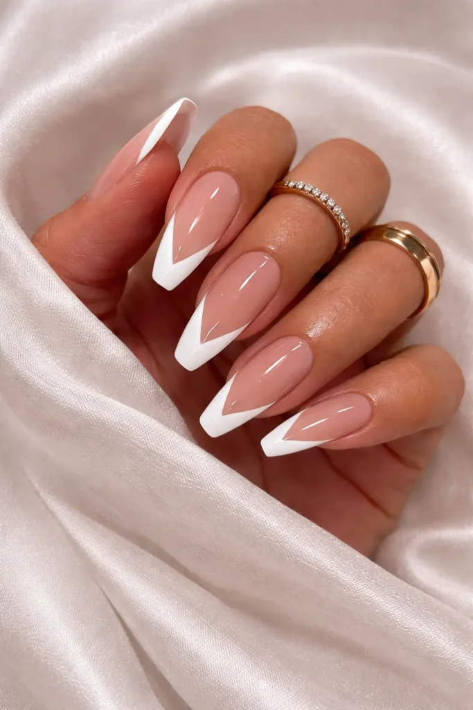 V shape french tip nails with sharp chevron white tip design on coffin nails
