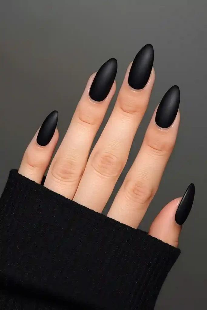 Velvet matte black almond nails with luxurious non-shiny finish
