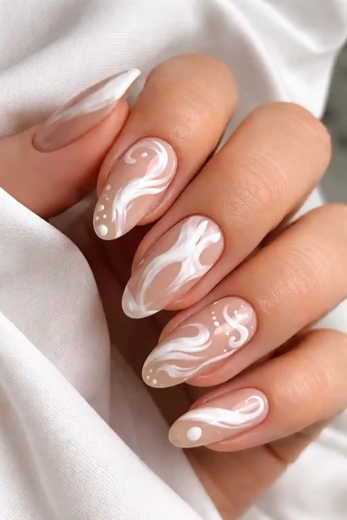 White abstract nail art with brushstroke marks and asymmetric shapes on a nude base