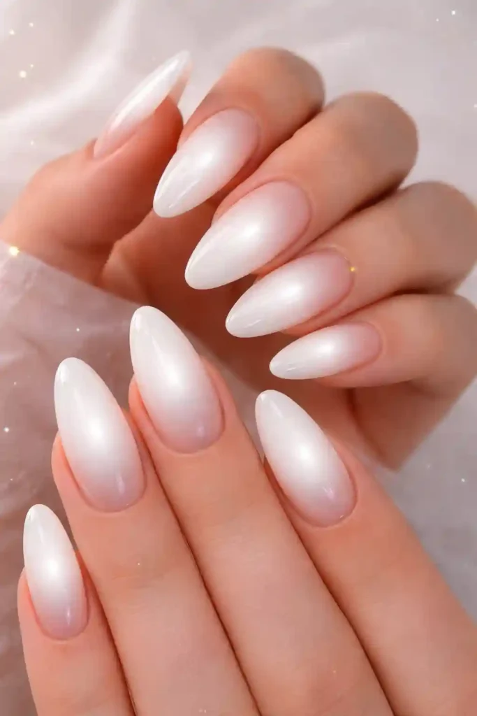 White aura nails with a soft blurred glow effect on a sheer nude base
