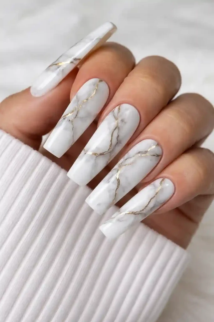 White marble nails with delicate grey veining on long square coffin nails