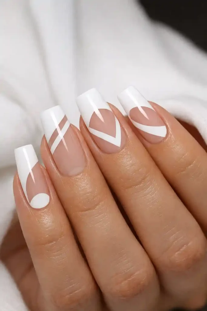 White negative space nails with geometric bare sections framed by white polish on square nails