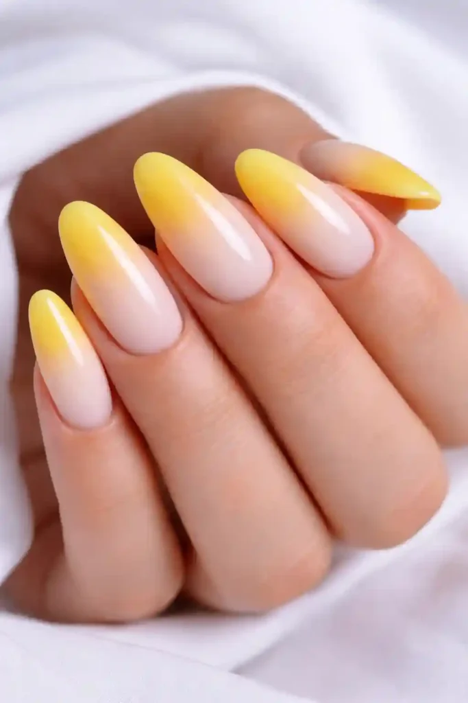 Yellow ombre nails fading to white
