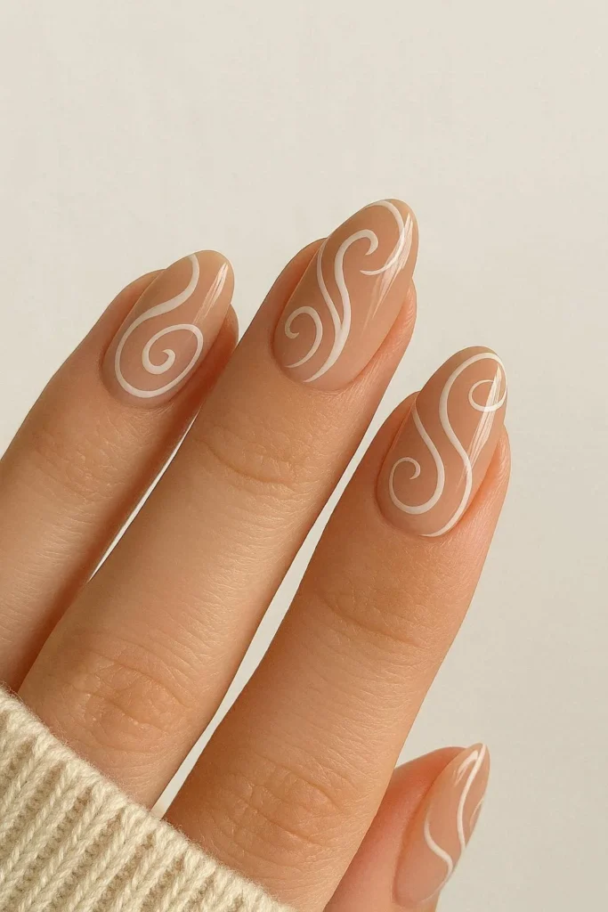 Beige and white swirl nails with a soft elegant design