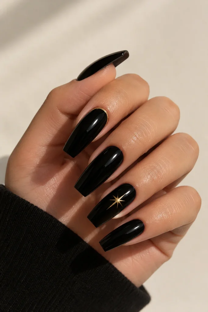 Glossy black nails with a fine gold sheriff star outline