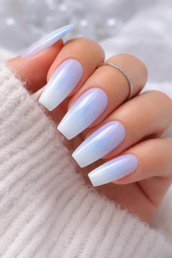 Blue and white ombre nails blended like winter sky gradient