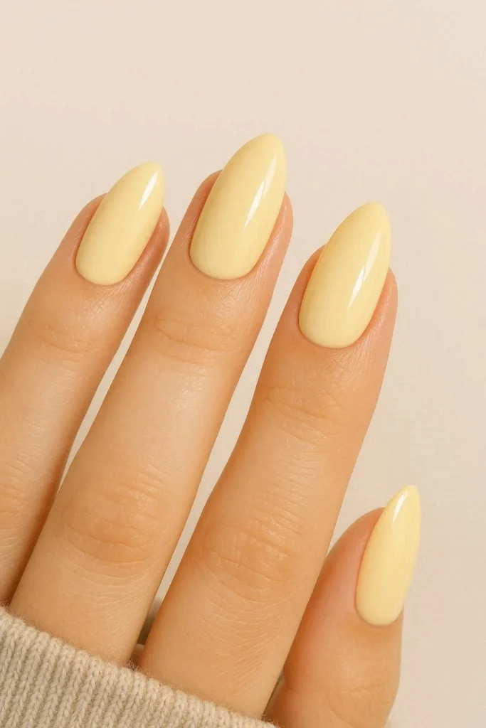Butter yellow almond shaped nails with creamy pastel finish