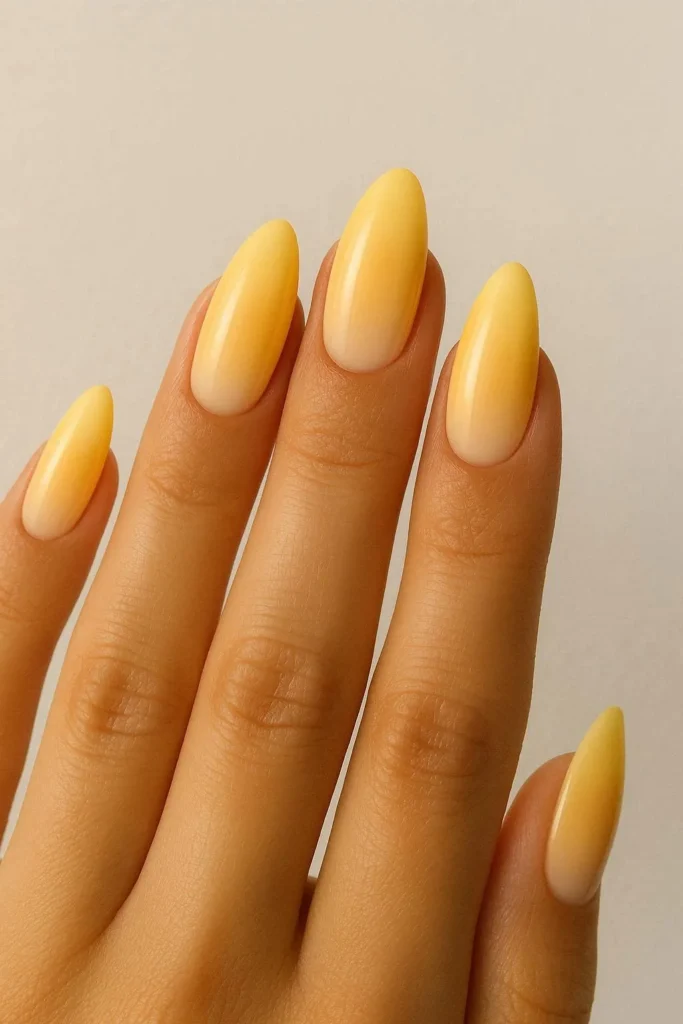 Butter yellow ombre nails fading into nude 