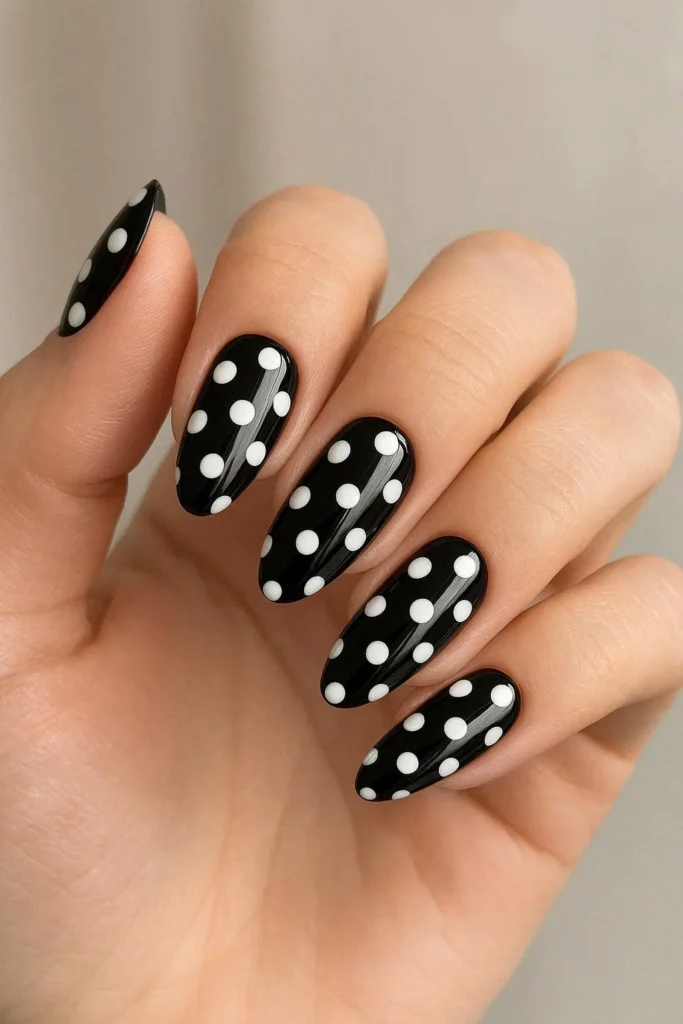 Classic black and white polka dot nails with glossy finish