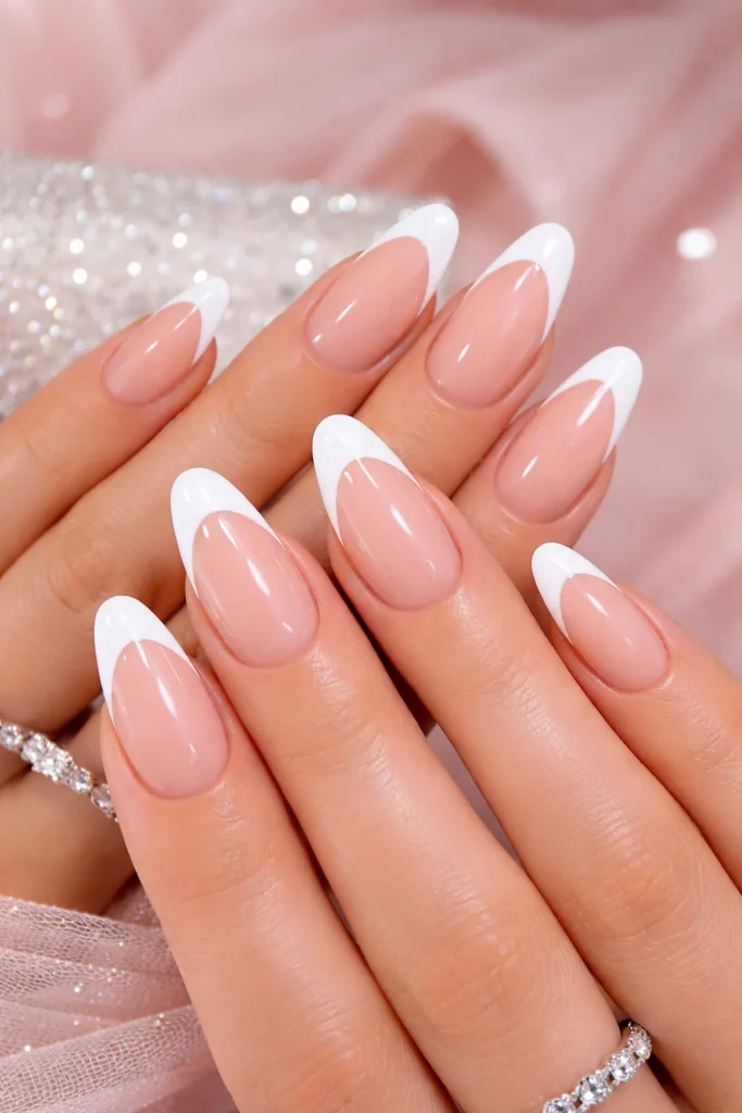 Classic French tip prom nails with nude base and crisp white tips