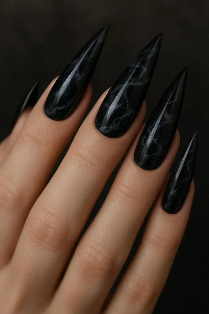 Dark marble stiletto nails with black and grey swirls