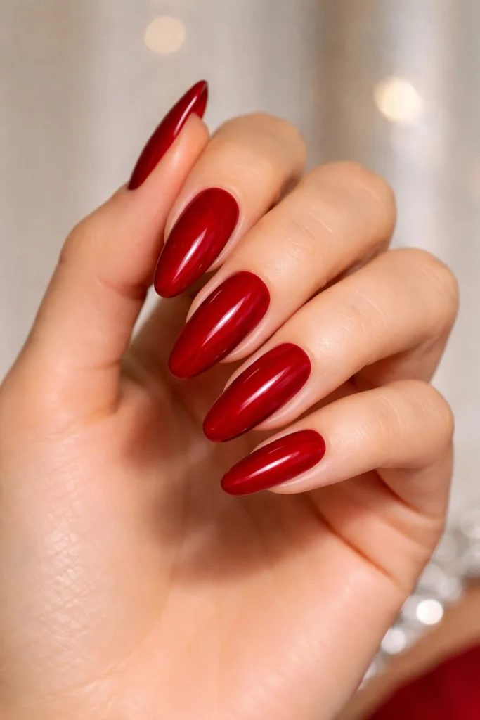Deep red glossy prom nails in classic crimson finish 