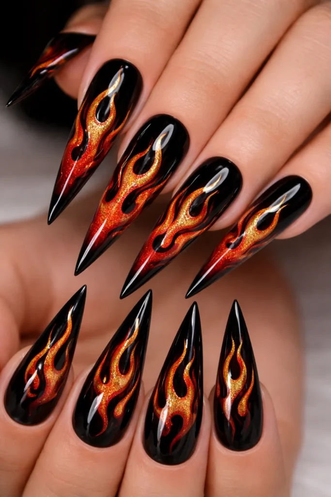 Flame design Leo nails in red orange and gold on black base