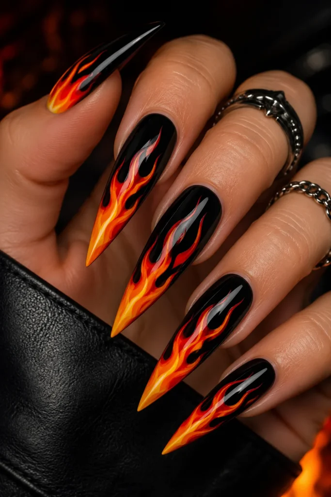 Flame design stiletto nails with bold orange red fire art 
