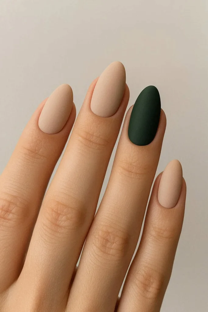 Forest green accent nails paired with soft neutral tones
