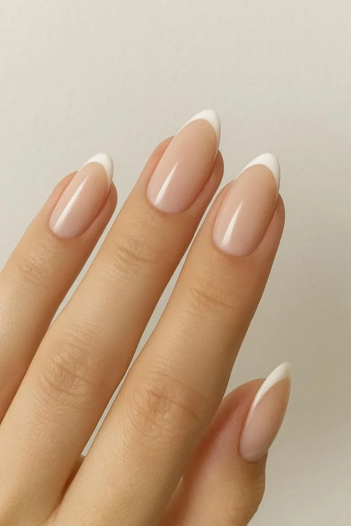 Minimal French tip nails on a soft nude base