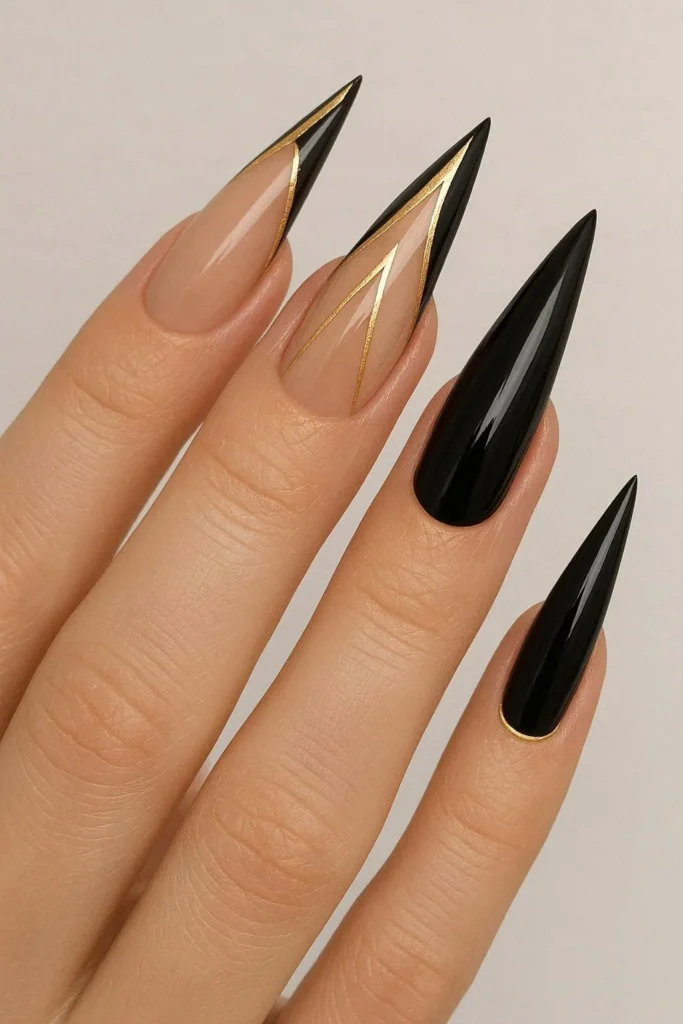 Gold accent stiletto nails with metallic foil line detailing